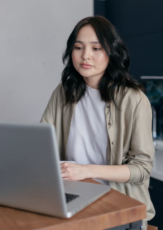 Woman in Beige Cardigan Using Laptop 